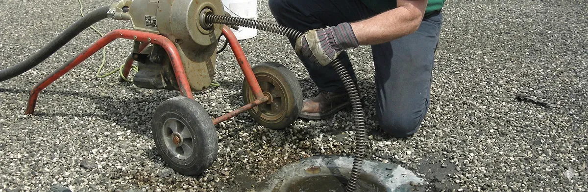 sewer rodding technician actively removing blockages from a sewer line in Baton Rouge, LA